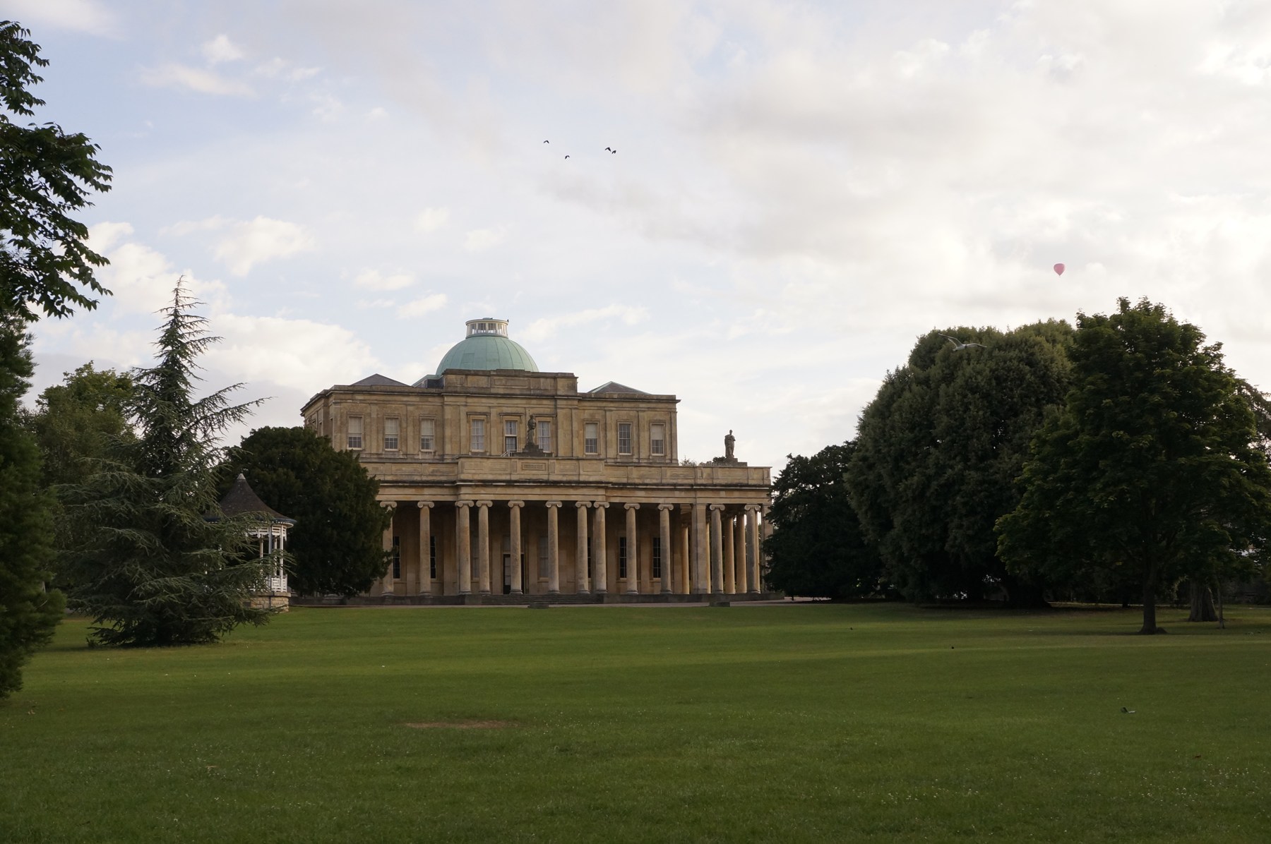 Pittville Pump Room behind its lawn in Cheltenham
